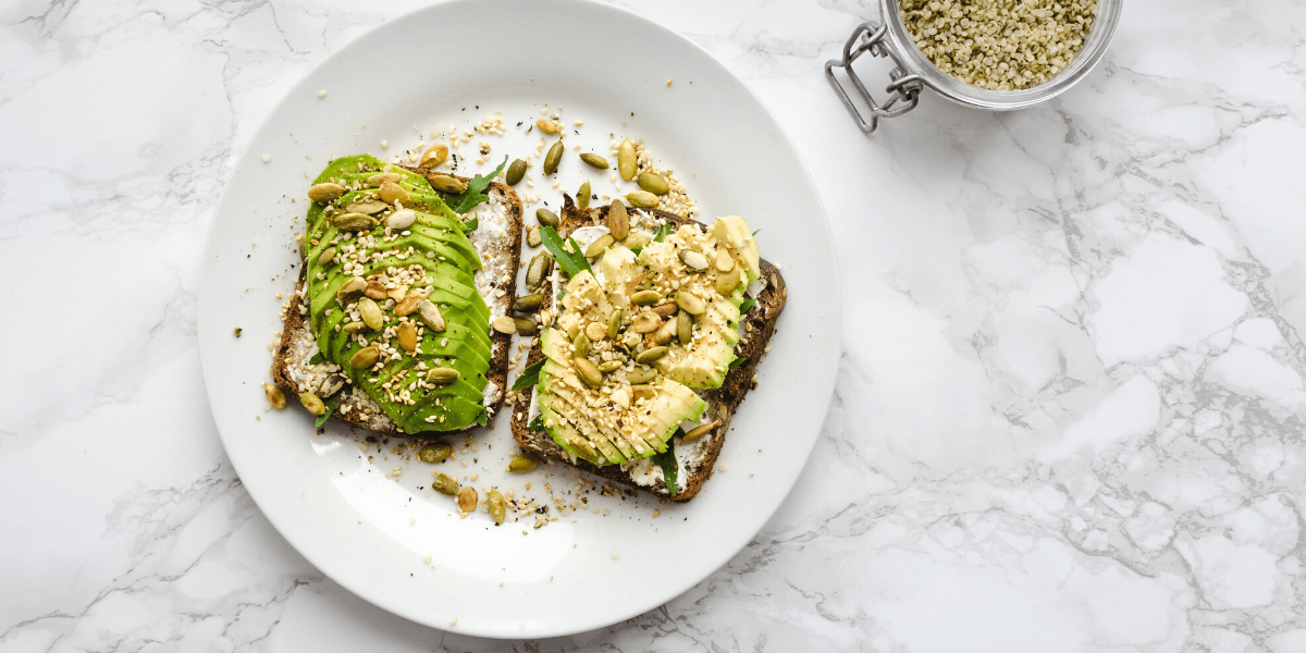 Avocado toast with pistachios and jar of quinoa